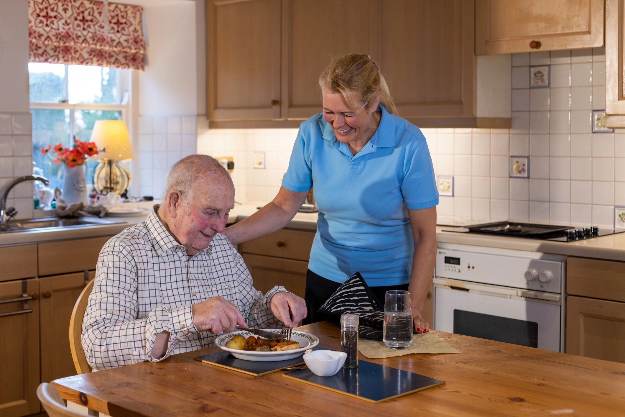 Care professional supporting an older person