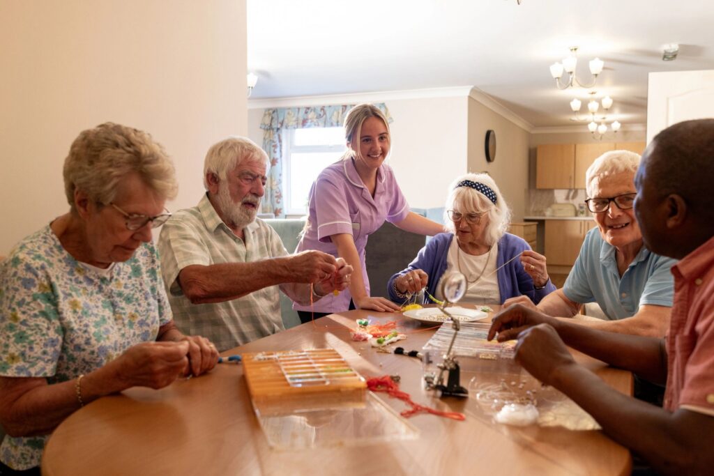 Aged care support worker with residents in a collaborative care setting