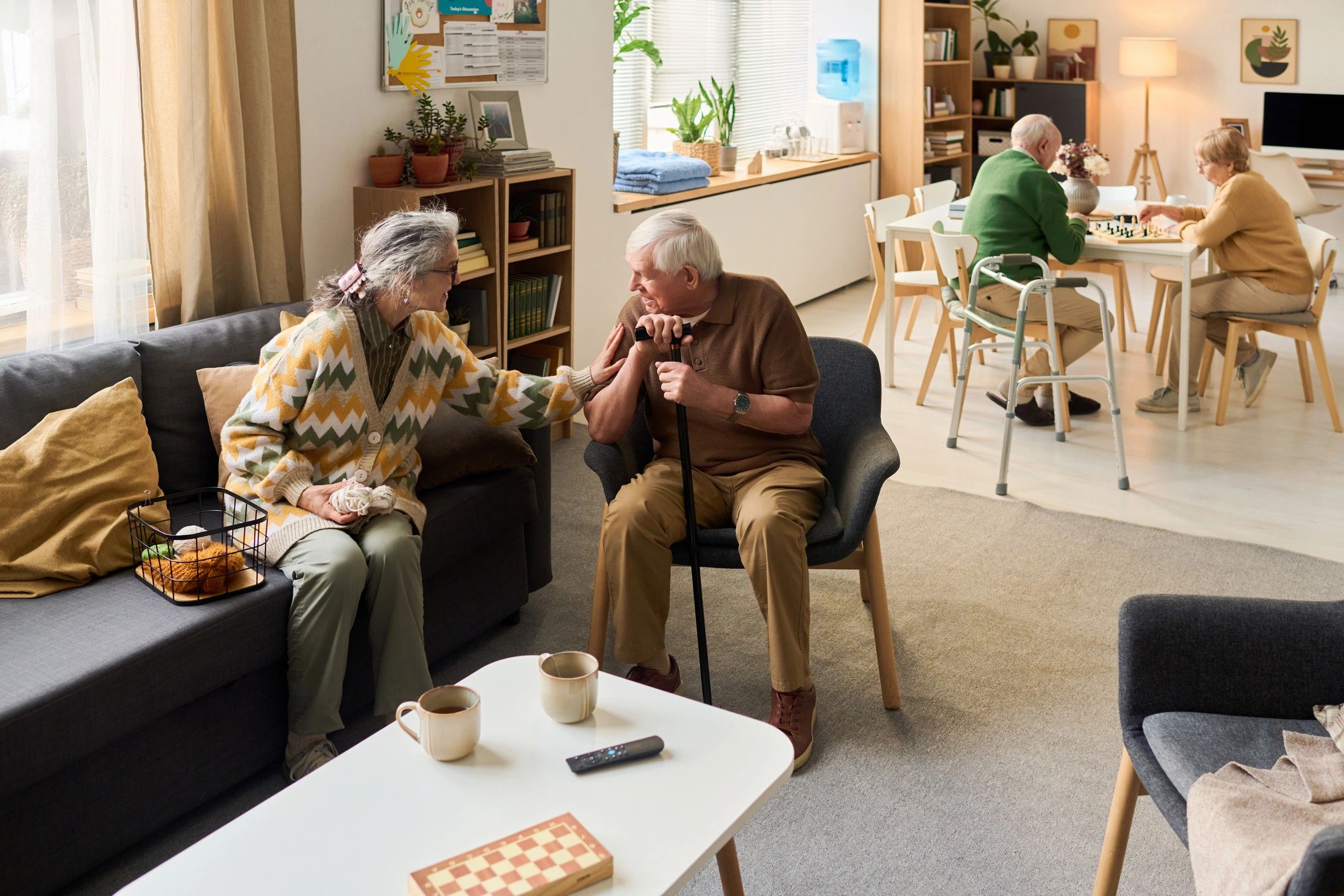 Senior residents socialising in a warm aged care community setting